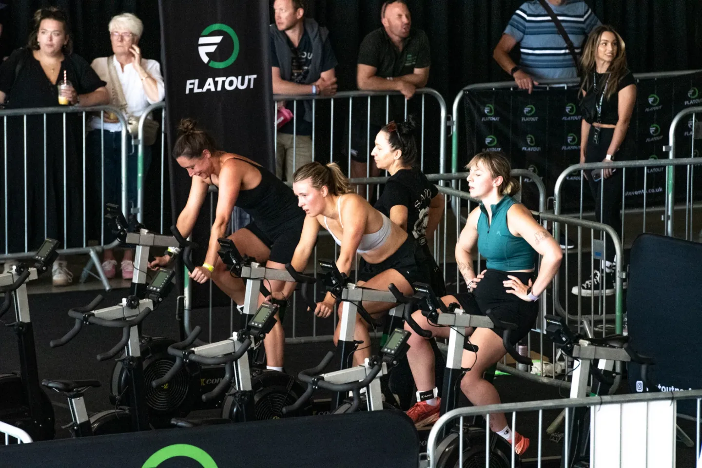 Participants racing on the bikes at a FLATOUT event